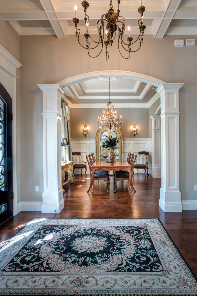Foyer - large transitional dark wood floor and brown floor foyer idea in Orlando with beige walls and a glass front door