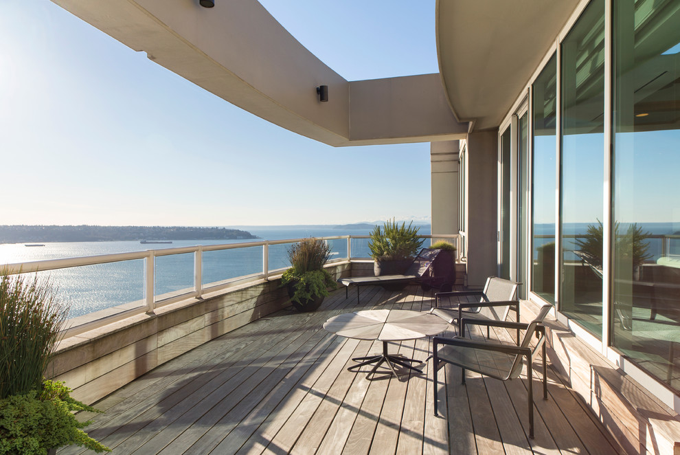 Design ideas for a contemporary balcony in Seattle with a roof extension.