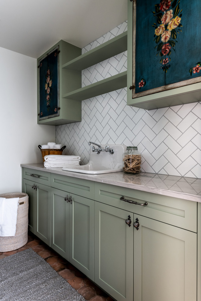 This is an example of a small traditional utility room in Seattle with a single-bowl sink, recessed-panel cabinets, marble worktops, white splashback, white walls, ceramic flooring, brown floors and beige worktops.
