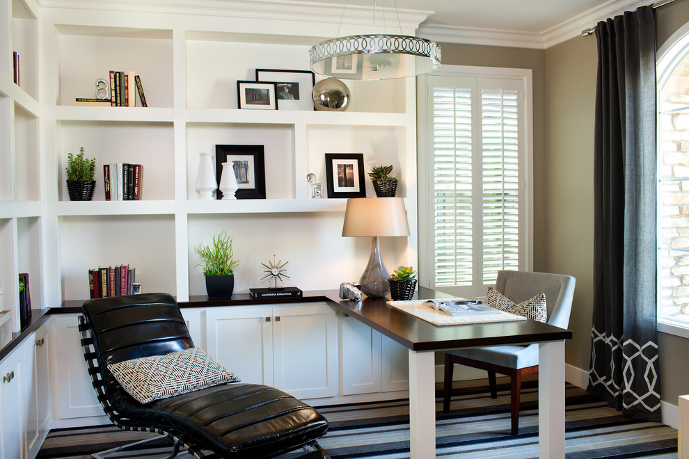Inspiration for a transitional home office in Los Angeles with beige walls, carpet and a built-in desk.