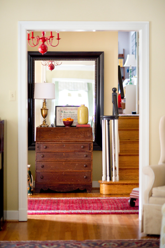 Mid-sized eclectic foyer in Other with beige walls, medium hardwood floors and a single front door.