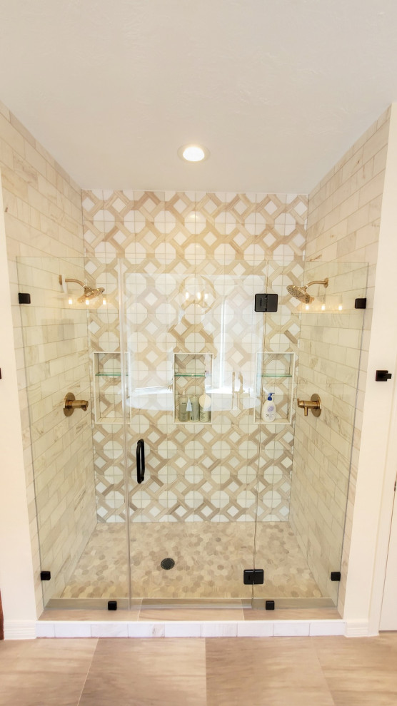 Example of a large transitional master white tile and marble tile porcelain tile, beige floor and single-sink bathroom design in Houston with shaker cabinets, brown cabinets, beige walls, a drop-in sink, quartz countertops, a hinged shower door, white countertops and a built-in vanity