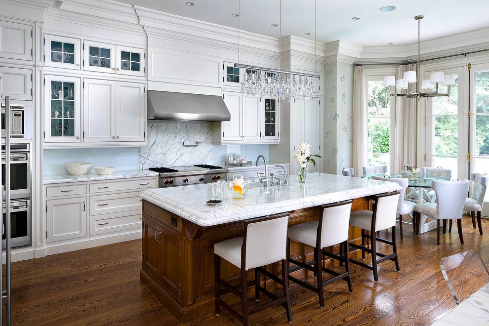 Inspiration for a traditional galley eat-in kitchen in Toronto with beaded inset cabinets, white cabinets, blue splashback, stainless steel appliances, medium hardwood floors and with island.