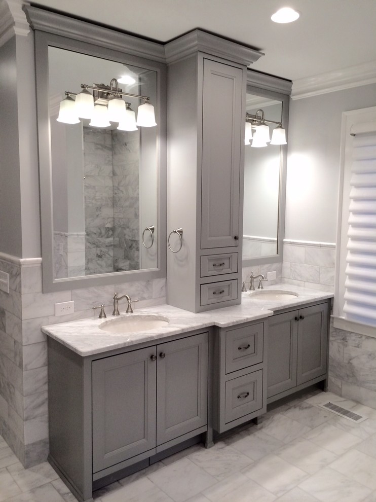 Example of a large transitional master gray tile and marble tile marble floor and gray floor corner shower design with recessed-panel cabinets, gray cabinets, a two-piece toilet, white walls, an undermount sink and marble countertops