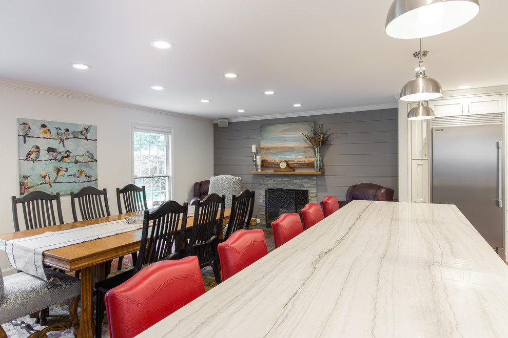 Example of a large transitional single-wall medium tone wood floor and brown floor eat-in kitchen design with an undermount sink, shaker cabinets, white cabinets, marble countertops, multicolored backsplash, matchstick tile backsplash, stainless steel appliances and two islands