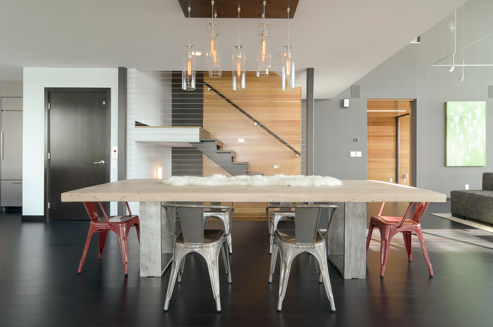 Design ideas for a contemporary dining room in Minneapolis with grey walls and black floor.