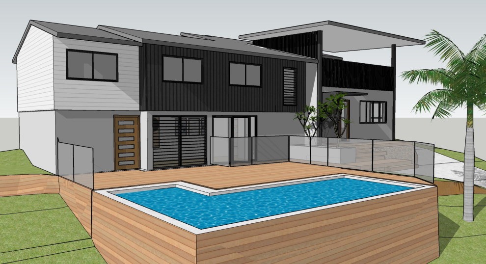 Mid-sized beach style courtyard and ground level deck in Sunshine Coast with no cover and glass railing.