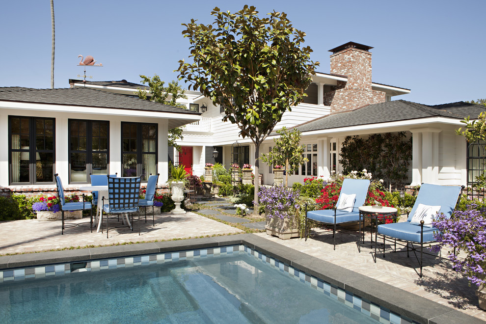 Inspiration for a mid-sized beach style backyard lap pool in San Diego with brick pavers.
