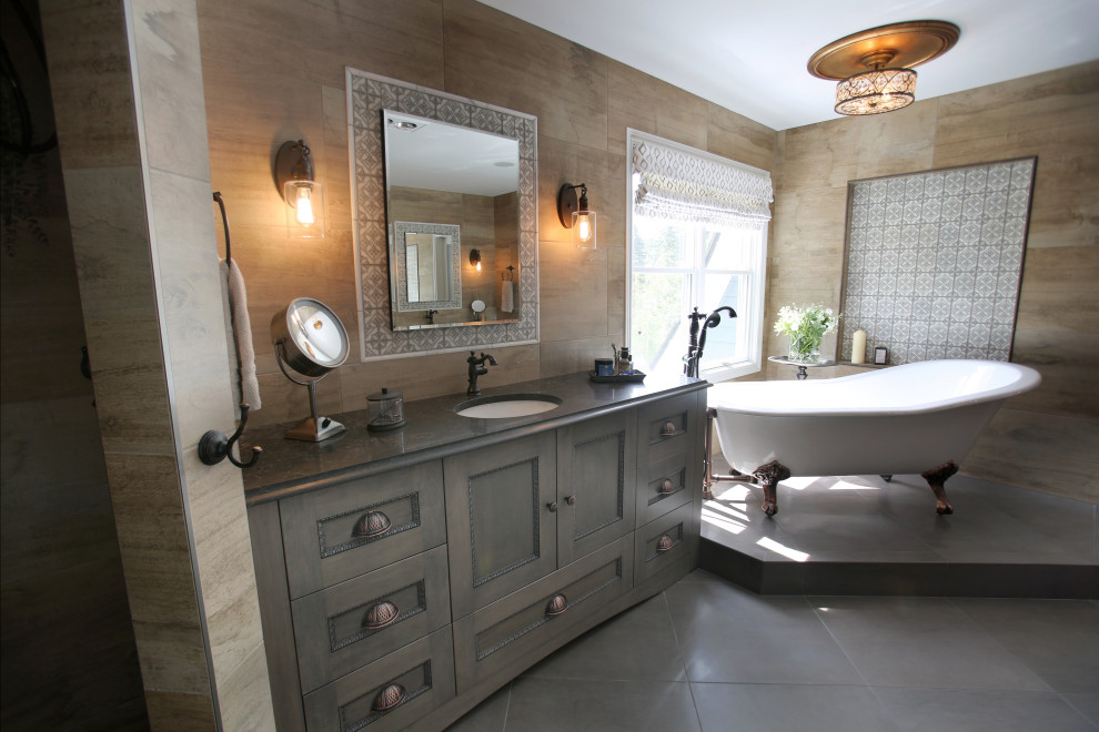 Photo of a large transitional master bathroom in Detroit with beaded inset cabinets, grey cabinets, a claw-foot tub, a corner shower, a one-piece toilet, gray tile, ceramic tile, grey walls, ceramic floors, an undermount sink, granite benchtops, grey floor, a hinged shower door, grey benchtops, an enclosed toilet, a single vanity and a freestanding vanity.