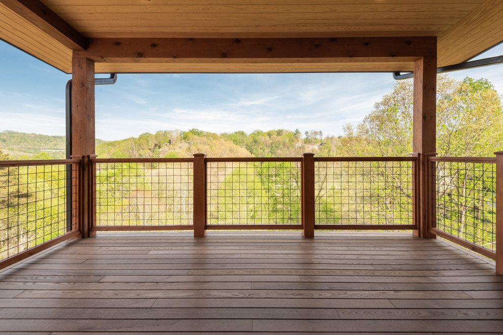 Deck - mid-sized transitional second story mixed material railing deck idea with a roof extension