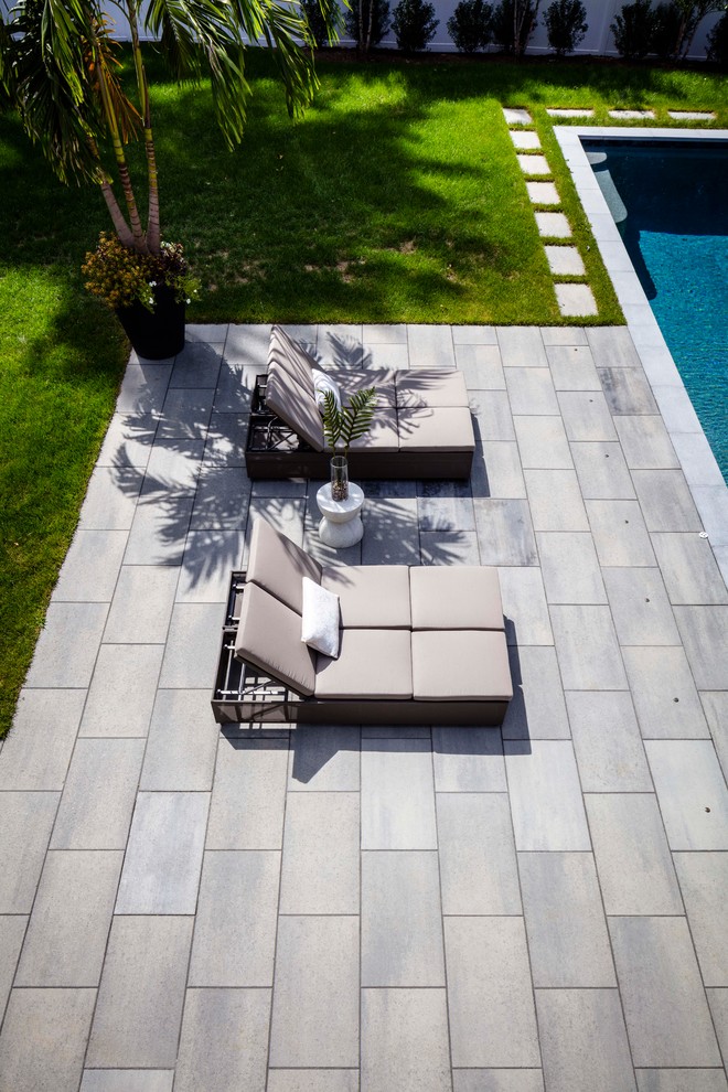 This is an example of a large contemporary garden in Other with concrete pavers.