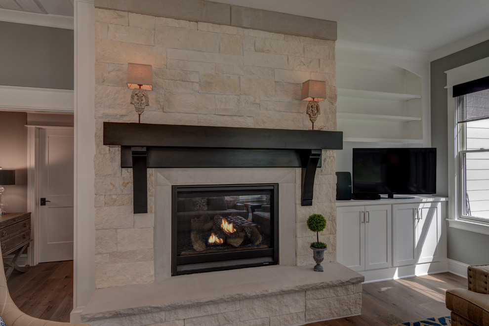 Inspiration for an arts and crafts open concept family room in Indianapolis with grey walls, medium hardwood floors, a standard fireplace, a tile fireplace surround, a corner tv and brown floor.