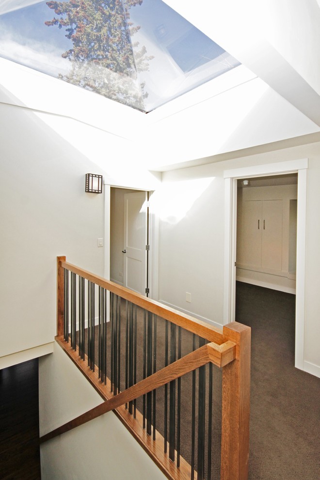 Example of a mid-sized transitional carpeted hallway design in Calgary with white walls
