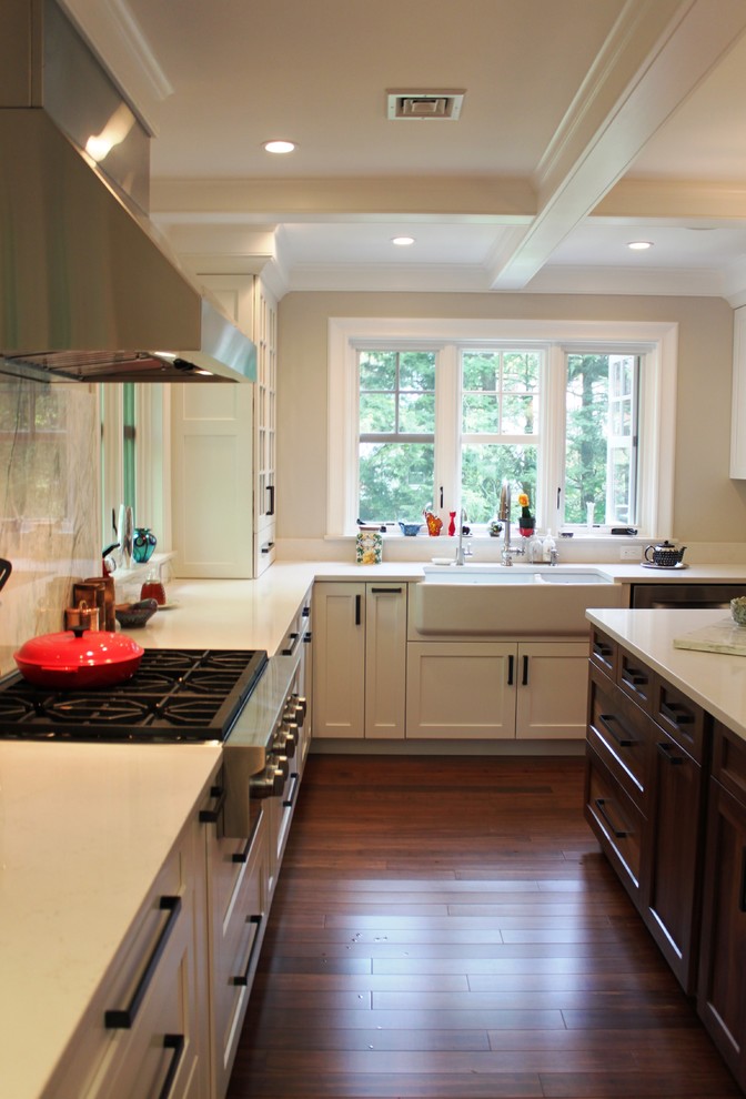 Design ideas for a mid-sized transitional u-shaped eat-in kitchen in Boston with a farmhouse sink, shaker cabinets, white cabinets, quartz benchtops, grey splashback, stone slab splashback, stainless steel appliances, dark hardwood floors and with island.