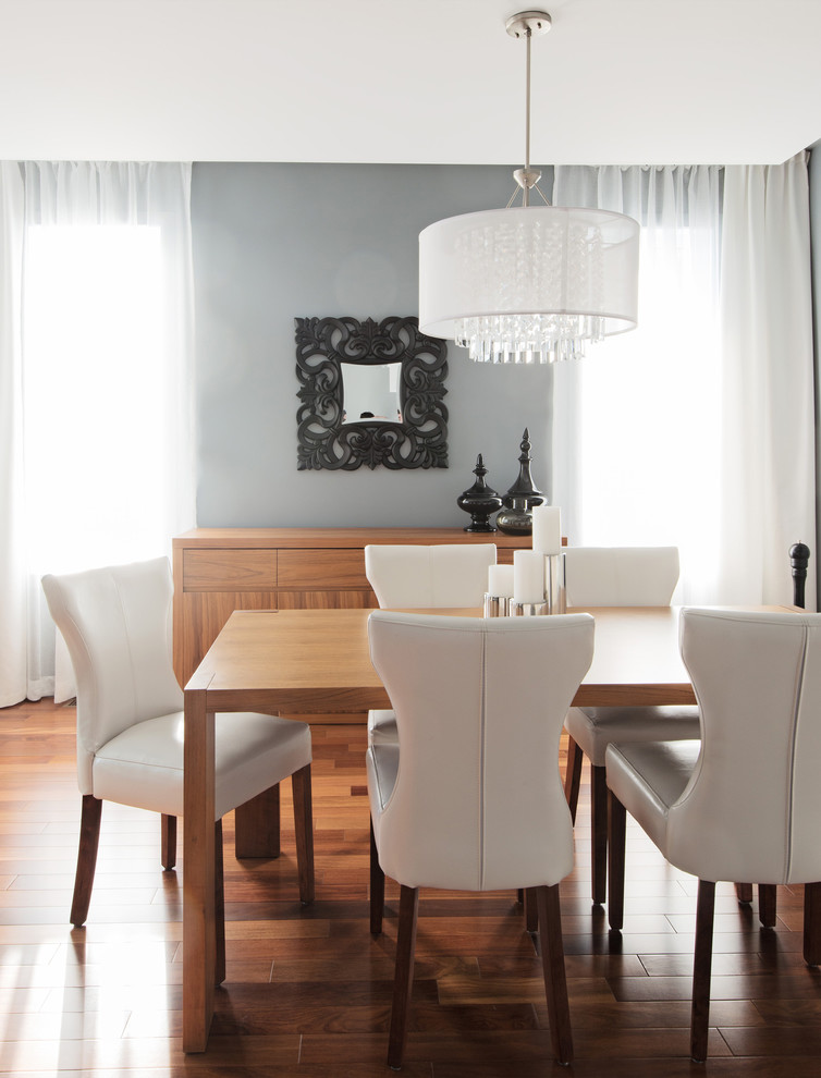 Contemporary dining room in Montreal with grey walls and dark hardwood floors.