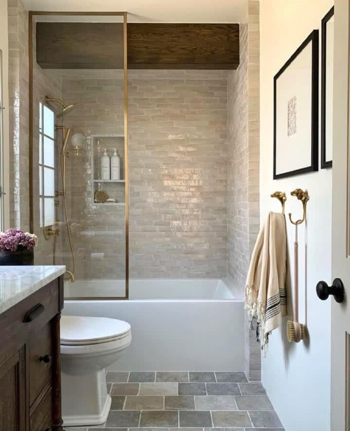 This is an example of a large country master bathroom in Orange County with shaker cabinets, brown cabinets, a freestanding tub, an alcove shower, a two-piece toilet, multi-coloured tile, ceramic tile, white walls, ceramic floors, an undermount sink, engineered quartz benchtops, multi-coloured floor, a hinged shower door, multi-coloured benchtops, a shower seat, a double vanity, a built-in vanity, recessed and decorative wall panelling.