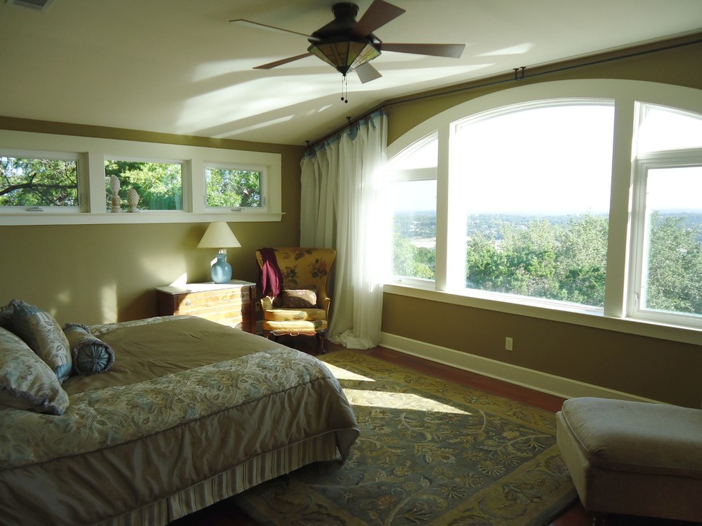 Arts and crafts master bedroom in Austin with brown walls and medium hardwood floors.