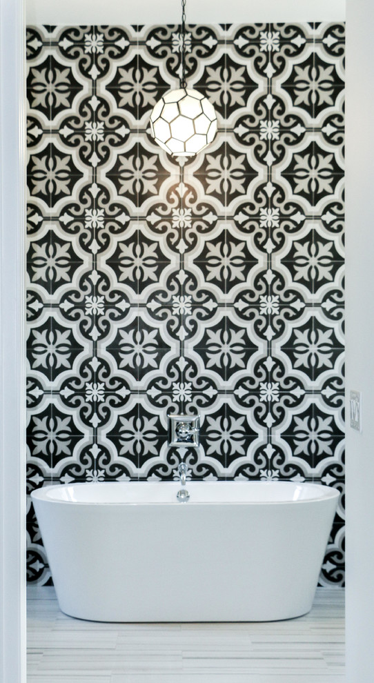 Photo of a mid-sized modern master bathroom in Orlando with shaker cabinets, white cabinets, a freestanding tub, a double shower, a one-piece toilet, black and white tile, porcelain tile, white walls, ceramic floors, a drop-in sink, engineered quartz benchtops, multi-coloured floor and an open shower.