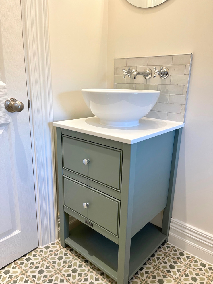 This is an example of a small traditional bathroom in Hertfordshire with green cabinets, a single sink and a freestanding vanity unit.