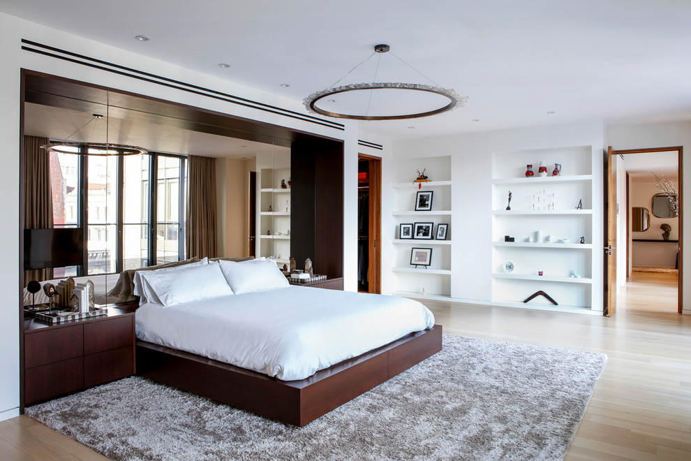 Inspiration for a large contemporary master bedroom in New York with white walls, light hardwood floors, no fireplace and beige floor.