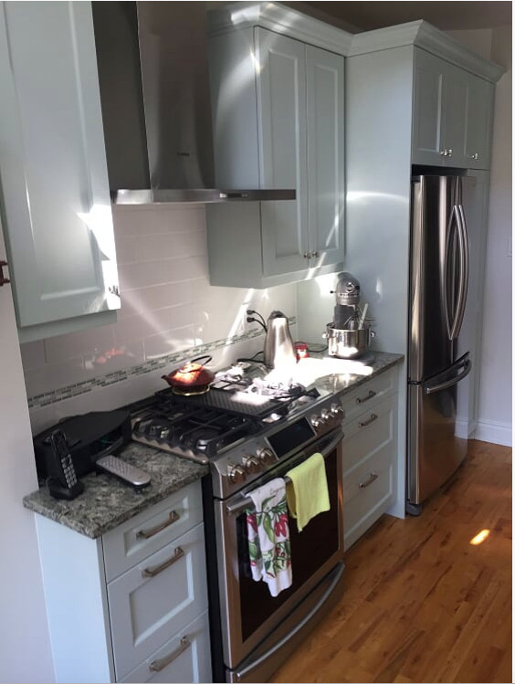 Inspiration for a mid-sized transitional galley medium tone wood floor and brown floor enclosed kitchen remodel in Ottawa with a double-bowl sink, recessed-panel cabinets, gray cabinets, granite countertops, porcelain backsplash, stainless steel appliances and gray countertops