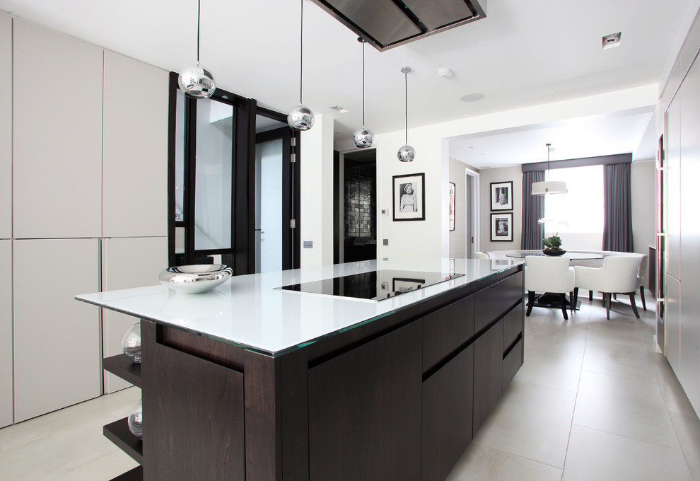 Contemporary u-shaped eat-in kitchen in London with flat-panel cabinets and with island.