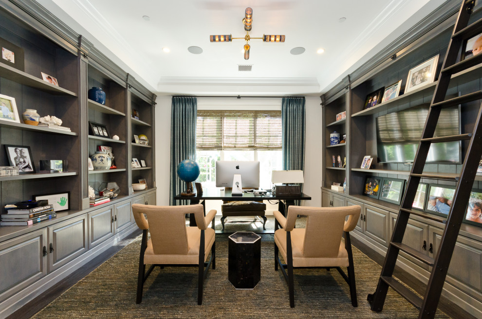 Transitional home office in Los Angeles with white walls, dark hardwood floors, a freestanding desk and brown floor.
