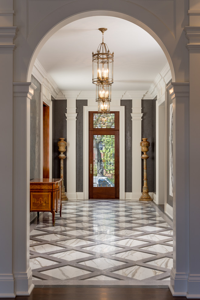 This is an example of a large traditional hallway in Toronto with black walls, marble floors and white floor.