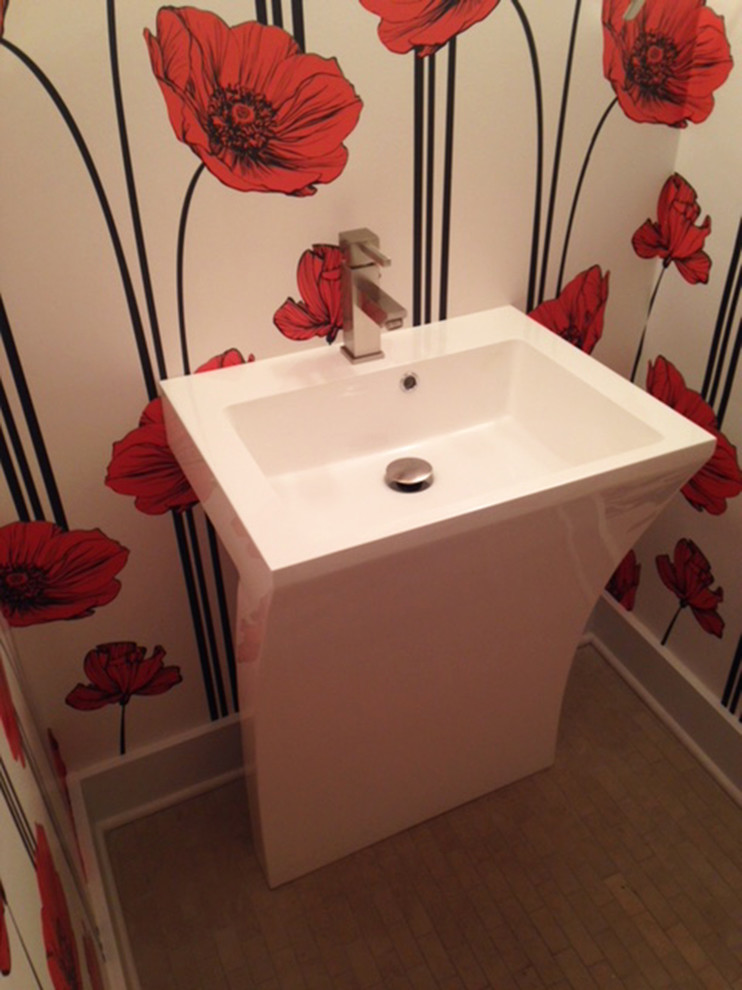 Photo of a small contemporary bathroom in Detroit with a one-piece toilet, orange walls, ceramic floors, a pedestal sink and beige floor.