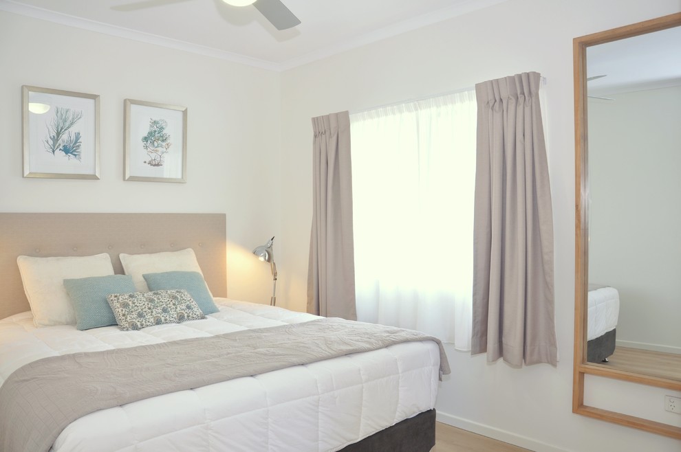Inspiration for a beach style master bedroom in Sunshine Coast with white walls, vinyl floors and beige floor.