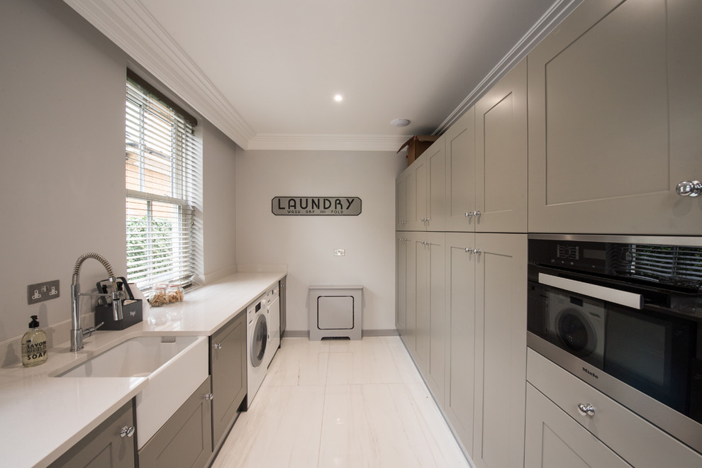 Contemporary laundry room in London with porcelain floors and beige floor.