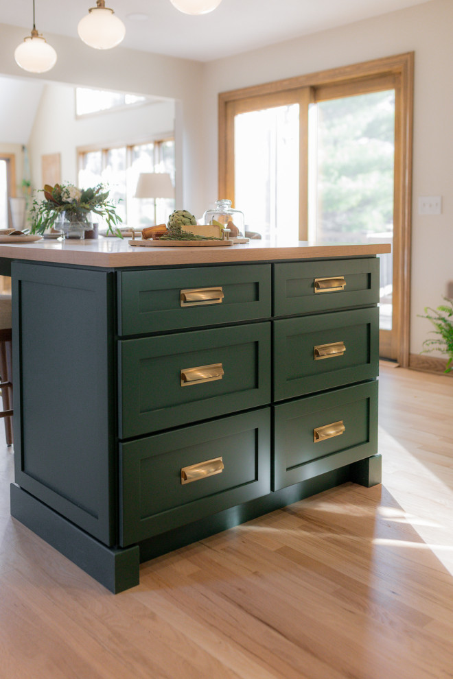 Eat-in kitchen - mid-sized transitional l-shaped light wood floor and brown floor eat-in kitchen idea with an undermount sink, recessed-panel cabinets, green cabinets, quartz countertops, beige backsplash, terra-cotta backsplash, stainless steel appliances, two islands and beige countertops