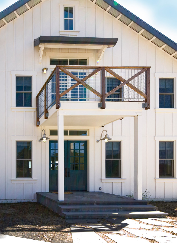 This is an example of a mid-sized country two-storey white exterior in San Francisco with wood siding.