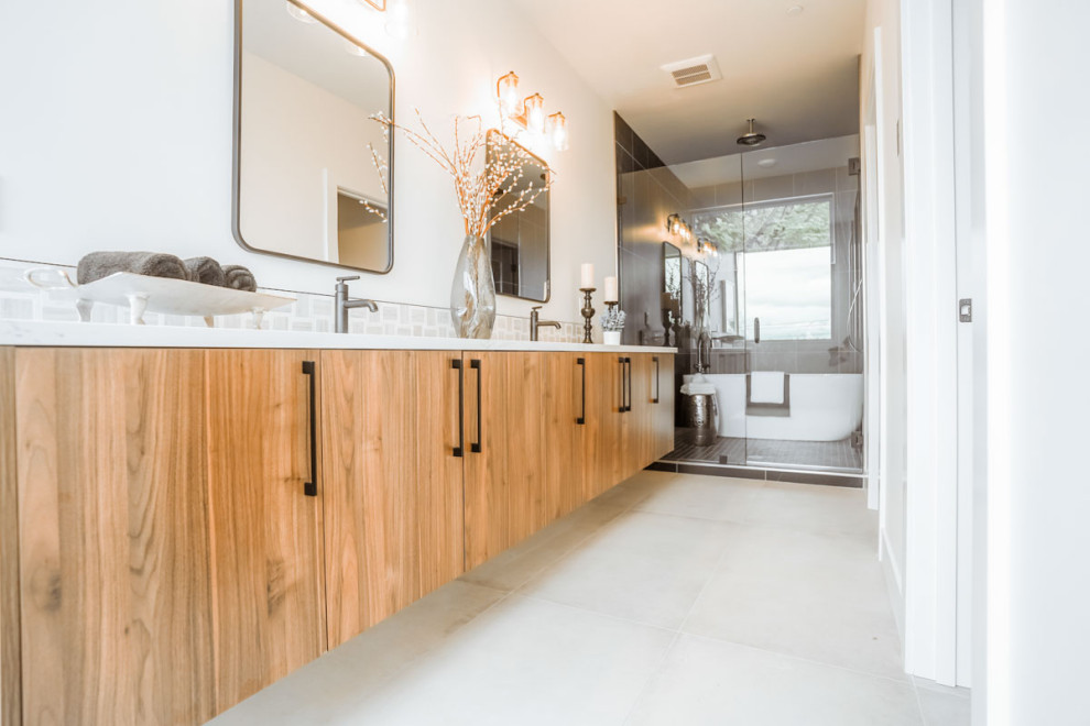 This is an example of a large contemporary master bathroom in Seattle with flat-panel cabinets, light wood cabinets, a freestanding tub, a corner shower, white tile, cement tile, white walls, cement tiles, an undermount sink, marble benchtops, white floor, a hinged shower door, white benchtops, a double vanity, a floating vanity and coffered.