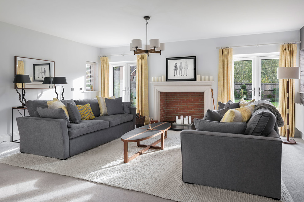 Mid-sized transitional formal enclosed living room in Hampshire with grey walls, carpet, a standard fireplace, grey floor and a brick fireplace surround.