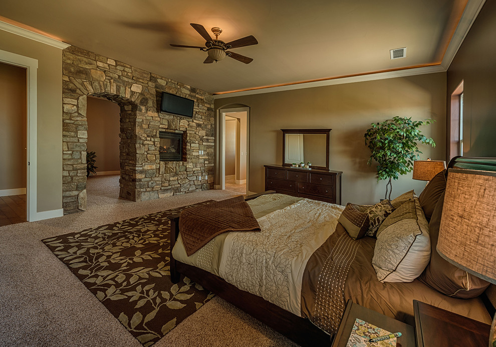 Photo of a large country master bedroom in Other with brown walls and a two-sided fireplace.