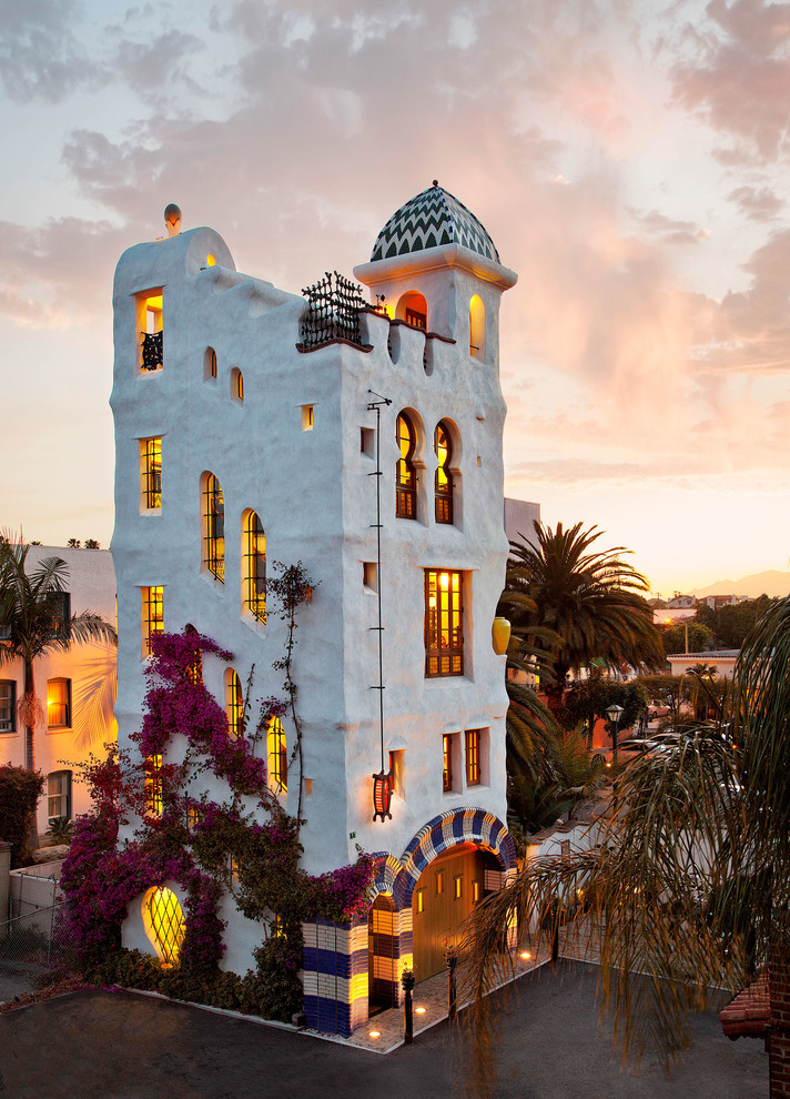 Inspiration for an expansive mediterranean three-storey stucco white apartment exterior in Santa Barbara.
