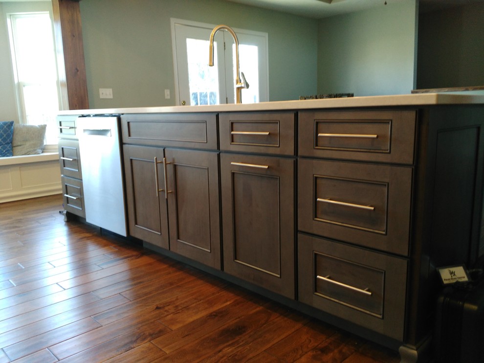 Inspiration for a mid-sized transitional l-shaped dark wood floor and brown floor eat-in kitchen remodel with a single-bowl sink, shaker cabinets, white cabinets, quartzite countertops, gray backsplash, ceramic backsplash, stainless steel appliances and an island