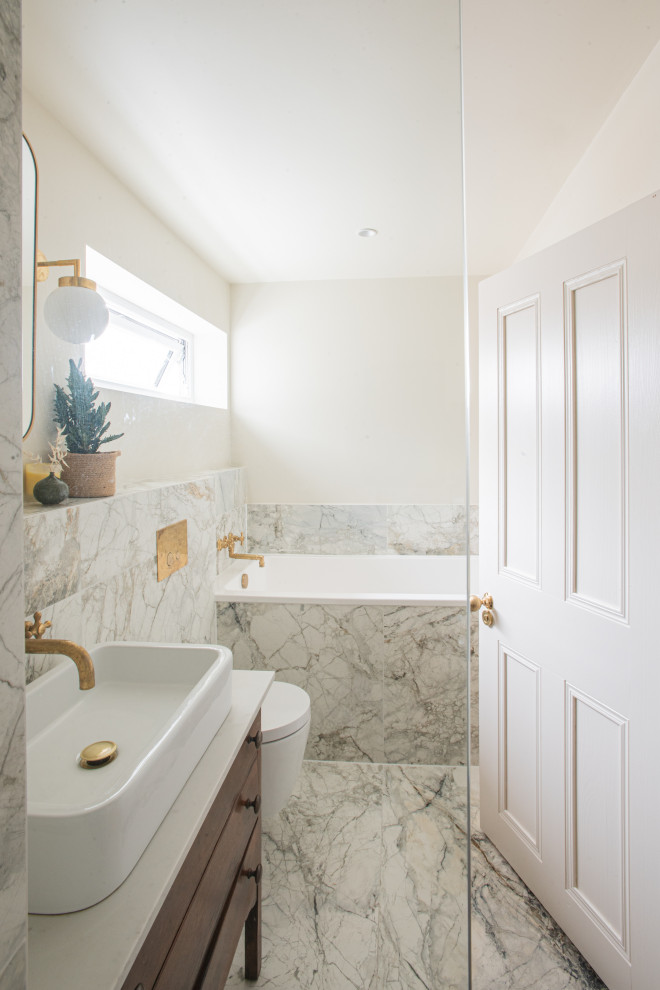 Inspiration for a mid-sized 1950s beige tile and porcelain tile porcelain tile, beige floor and single-sink bathroom remodel in London with furniture-like cabinets, dark wood cabinets, a wall-mount toilet, beige walls, quartz countertops, beige countertops, a niche and a freestanding vanity