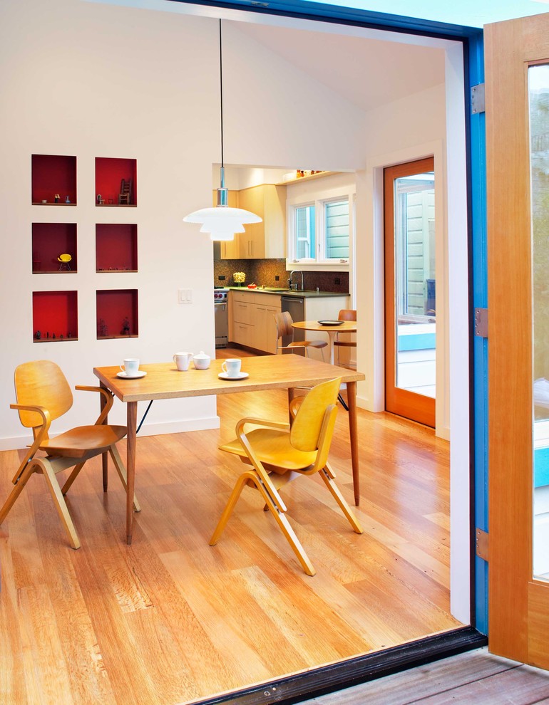 Photo of a mid-sized contemporary separate dining room in San Francisco with white walls, medium hardwood floors and no fireplace.
