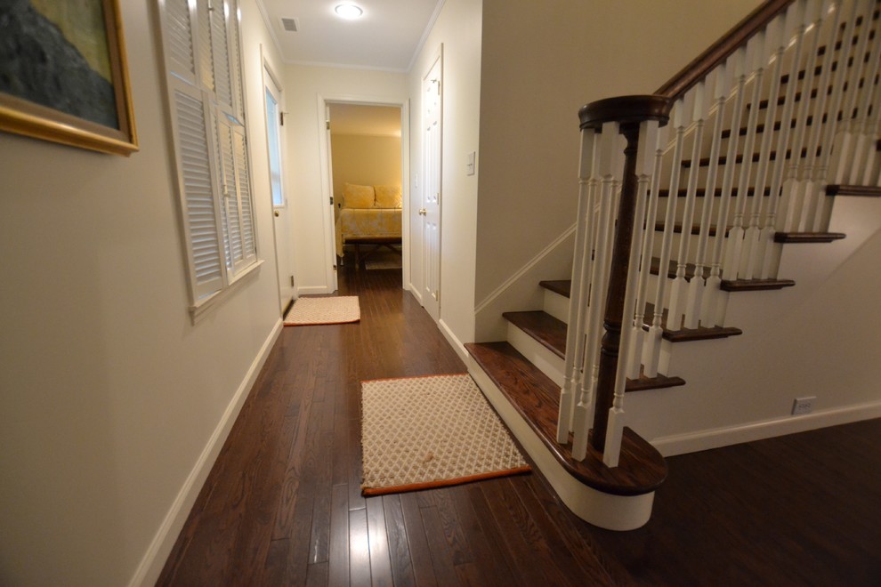 Example of a dark wood floor and brown floor basement design with white walls