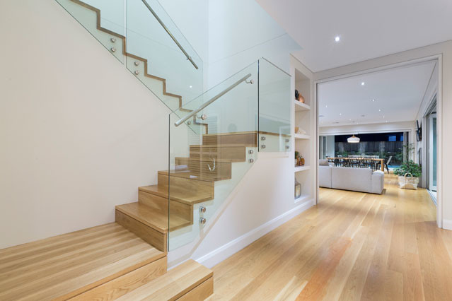 Contemporary wood staircase in Sydney with wood risers.