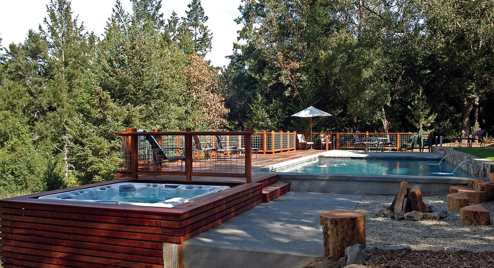 Large mountain style backyard rectangular aboveground hot tub photo in Los Angeles with decking