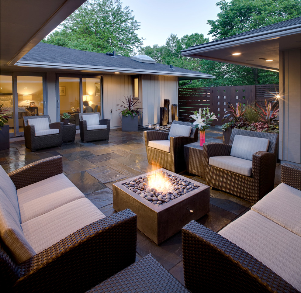 Inspiration for a transitional patio in Minneapolis with a fire feature, natural stone pavers and no cover.