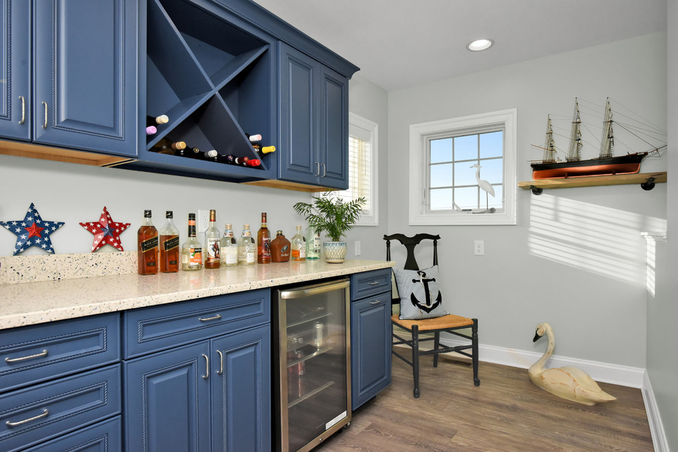 Small eclectic galley vinyl floor and brown floor dry bar photo in Other with raised-panel cabinets, blue cabinets, quartzite countertops and white countertops