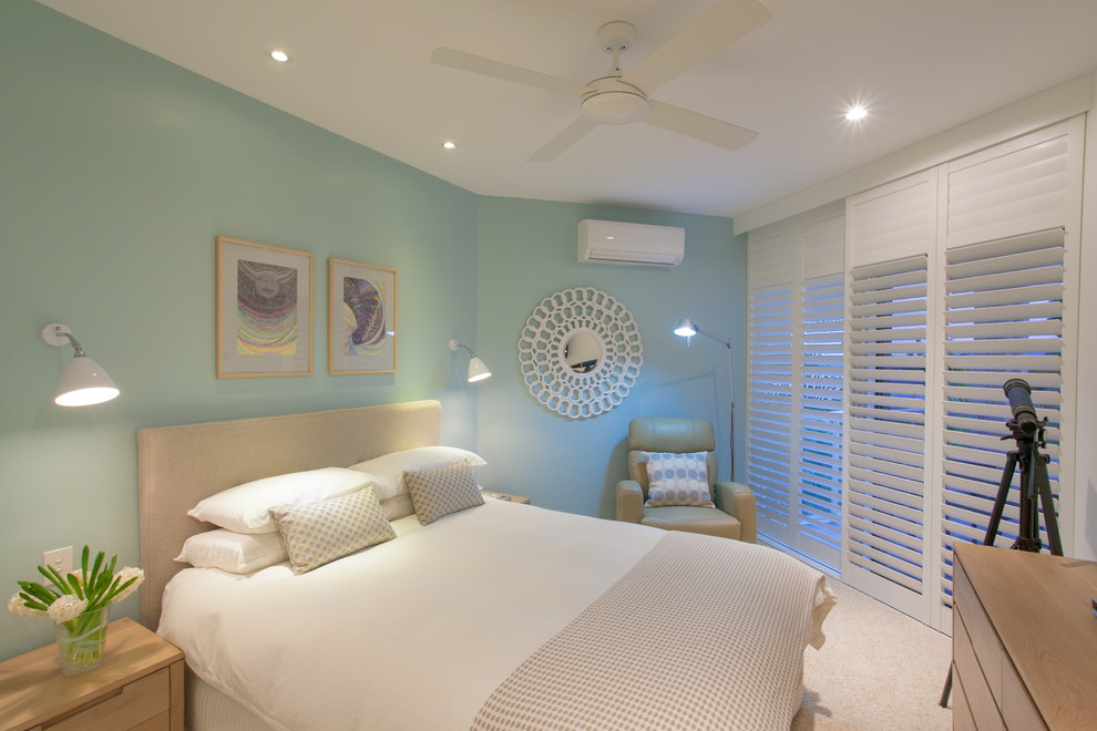 Photo of a beach style master bedroom in Sunshine Coast with blue walls and carpet.