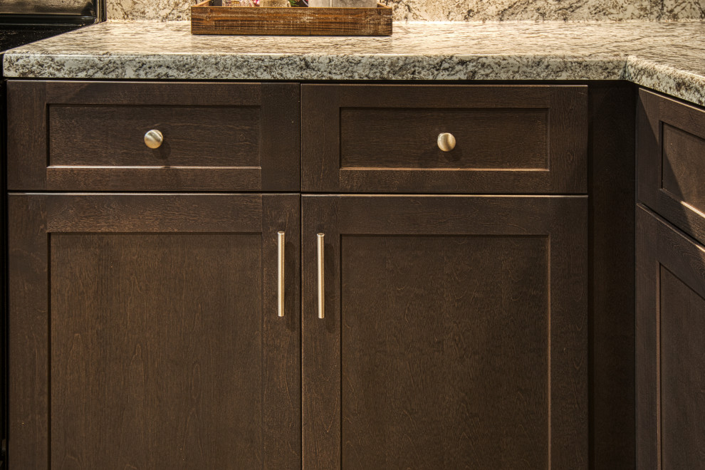 Mid-sized transitional u-shaped light wood floor and brown floor open concept kitchen photo with a drop-in sink, shaker cabinets, gray cabinets, laminate countertops, white backsplash, subway tile backsplash, stainless steel appliances, a peninsula and white countertops