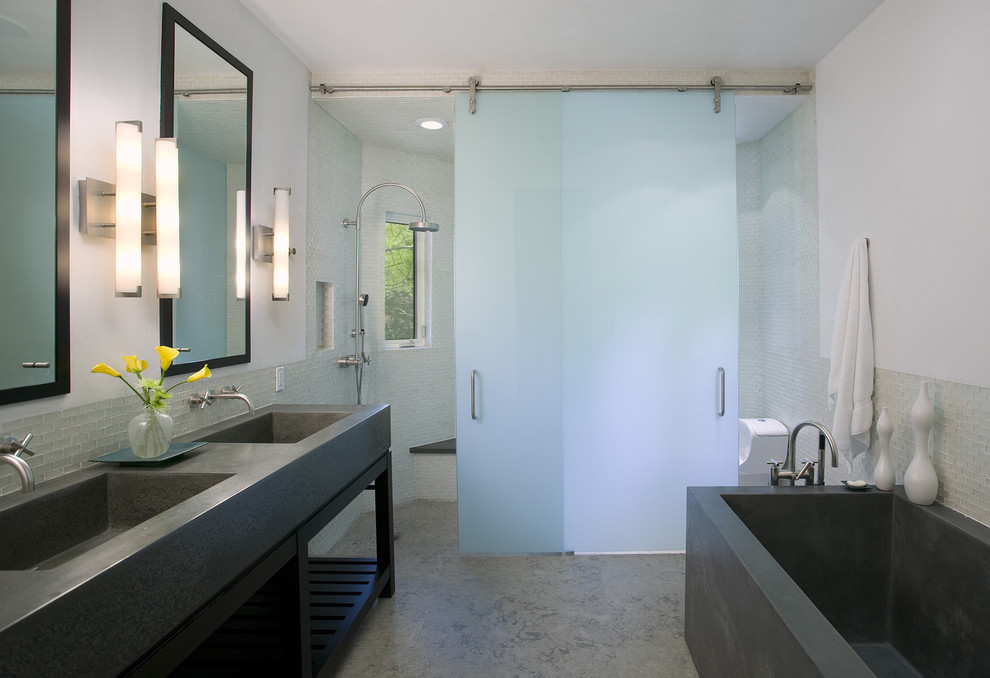 Inspiration for a contemporary bathroom in San Francisco with concrete benchtops, open cabinets and concrete floors.