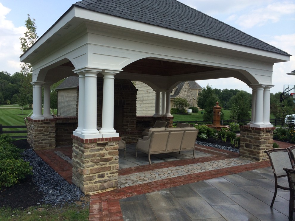 Inspiration for a large country backyard patio in Columbus with a fire feature, concrete pavers and a gazebo/cabana.
