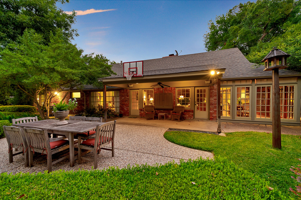 Traditional backyard patio in Dallas with a roof extension.
